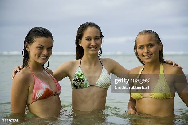 portrait of three teenage girls in the sea - young teen bathing suit stock pictures, royalty-free photos & images