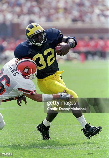 Anthony Thomas of the Michigan Wolverines avoids getting tackled during the game against the Bowling Green Falcons at Michigan Stadium in Ann Arbor,...