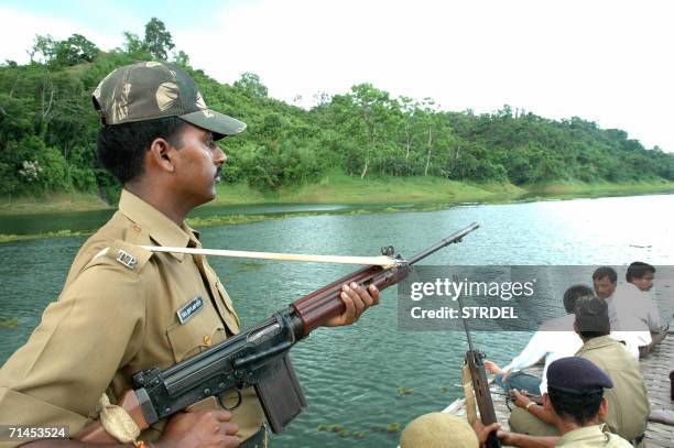 Under the shadow of police guns, tourists go on a boat trip on Dambur Lake, about 145 kms south of Agartala, capital of India?s north-eastern state...