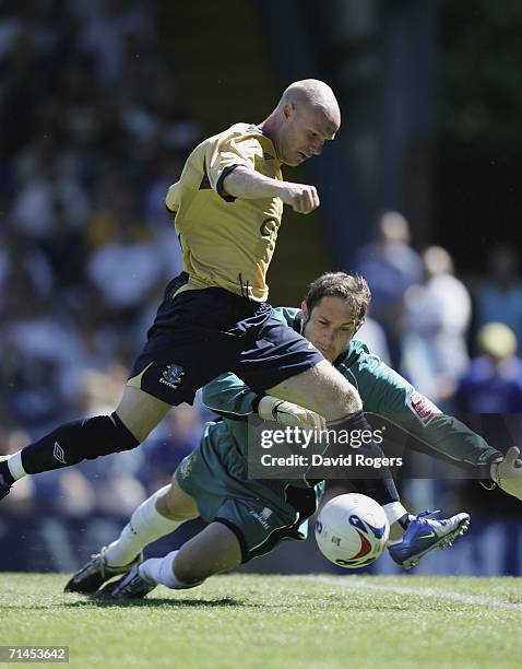 Andy Johnson, on his Everton debut, attempts to go round Bury goalkeeper Alan Fettis during the pre-season friendly match between Bury and Everton at...