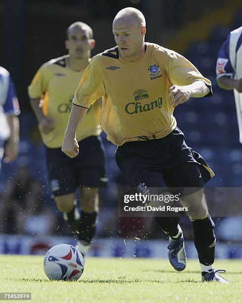 Andy Johnson, on his Everton debut, powers forward with the ball during the pre-season friendly match between Bury and Everton at Gigg Lane on...