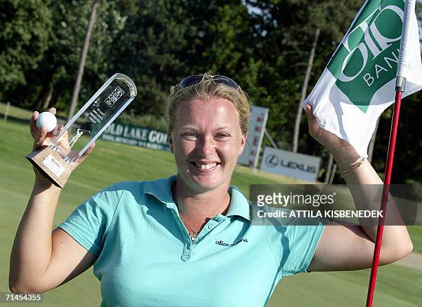 English Rebecca Hudson lifts her trophy and next to the flag of the 18th hole in the Old Lake Golf and Counrty Clun of Tata-Remetehegy 15 July 2006...