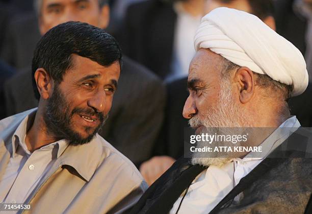 Iranian President Mahmoud Ahmadinejad talks with Hodjatoleslam Mohammad Gholpayghani , head of supreme leader Ali Khamenei's office, during the...