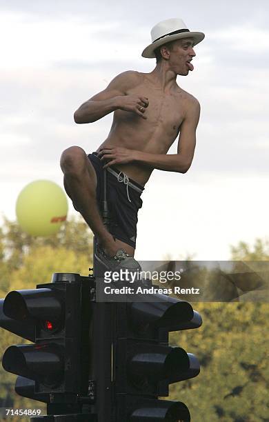 Man poses on a traffic light during the 16th annual Loveparade weekend July 15, 2006 in Berlin, Germany. Over 300 DJs on 39 trucks, so called...