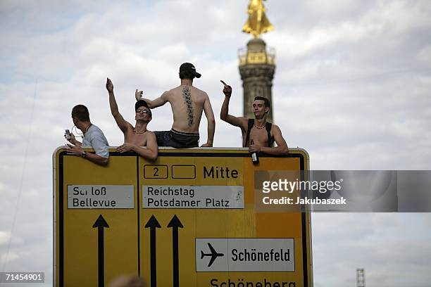 Participants sit at a traffic sign at the 16th annual Loveparade weekend July 15, 2006 in Berlin, Germany. Over 300 DJs on 39 trucks, so called...