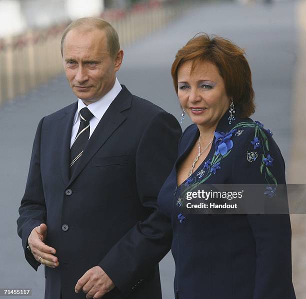 In this handout photo, Russia's President Vladimir Putin and his wife Lyudmila Putina await G8 leaders to attend an informal dinner of the G8 leaders...