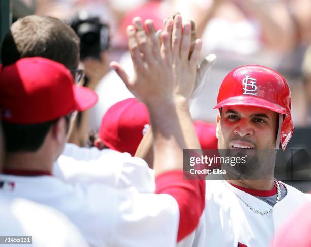 Albert Pujols of the St. Louis Cardinals is congratulated by teammates after he hit a solo home run against the Los Angeles Dodgers on July 15, 2006...