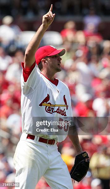 Relief pitcher Adam Wainwright of the St. Louis Cardinals points to a pop fly that was the final out of the 8th inning against the Los Angeles...