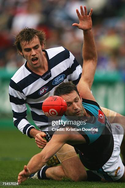 Matthew McCarthy of the Cats and Darryl Wakelin of the Power contest the ball during the round 15 AFL match between the Geelong Cats and the Port...