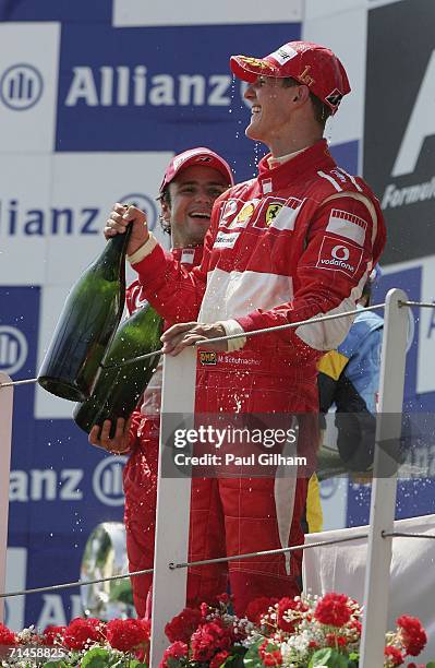 Michael Schumacher of Germany and Ferrari celebrates with Felipe Massa of Brazil and Ferrari after they finished first and second in the French...