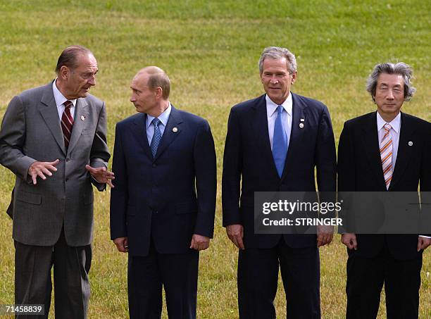 St Petersburg, RUSSIAN FEDERATION: French President Jacques Chirac talks to his Russian counterpart Vladimir Putin while posing with US President...