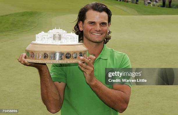 Johan Edfors of Sweden poses with the trophy following his victory after the final round of The Barclays Scottish Open at Loch Lomond Golf Club on...