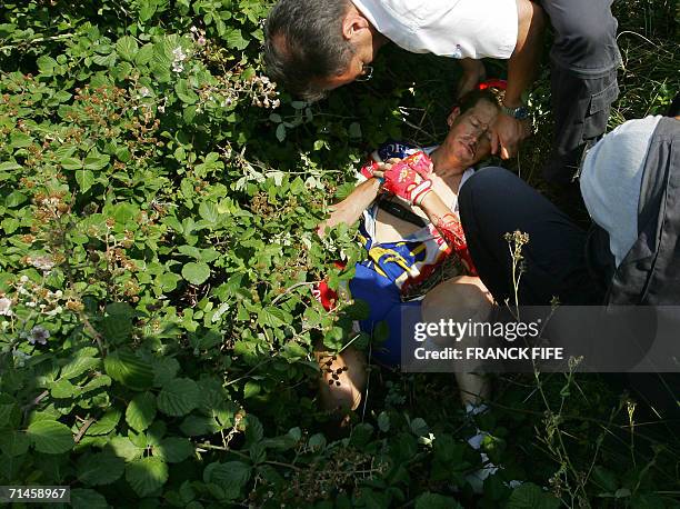 Belgium's Rik Verbrugghe is being taken care of after a fall during the 180.5 km fourteenth stage of the 93rd Tour de France cycling race from...