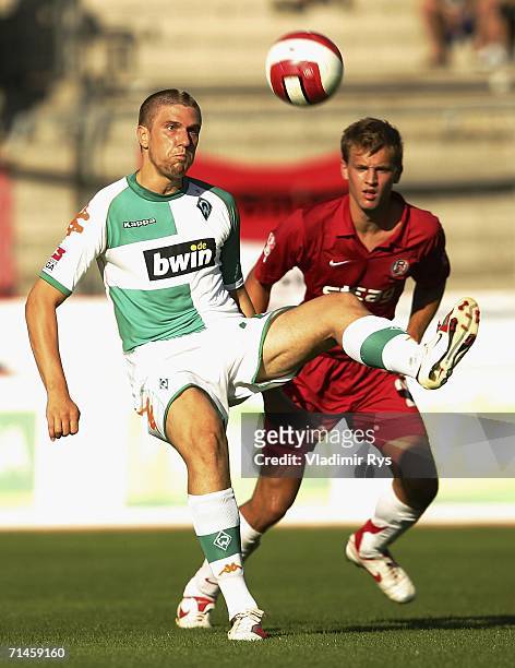 Ivan Klasnic of Bremen controlsthe ball as Pascal Bieler of Essen defends during the friendly match between Rot Weiss Essen and Werder Bremen at the...
