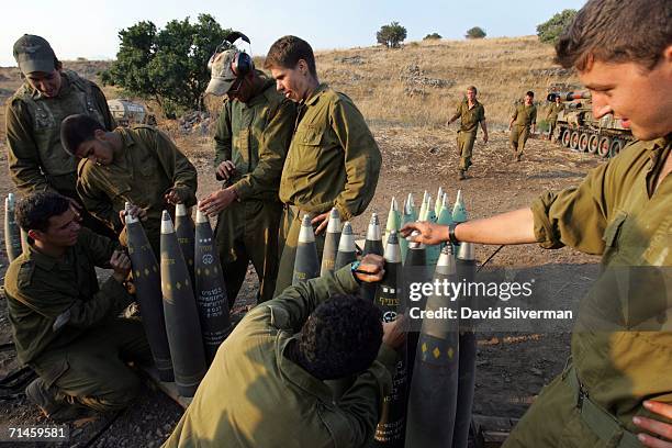 Israeli soldiers write messages to Hezbollah leader Sheikh Hassan Nasrallah on 155mm artillery shells before firing them at Hezbollah targets in...