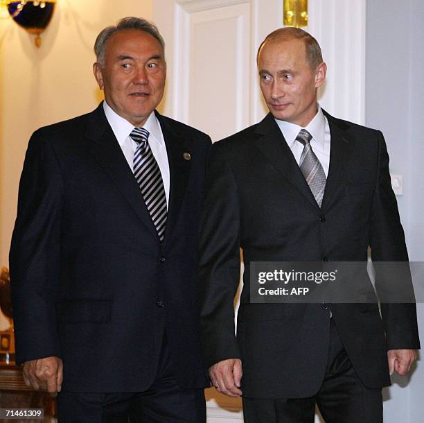 Russian President Vladimir Putin and his Kazakh counterpart Nursultan Nazarbayev enter a hall during their meeting in Konstantinovsky palace outside...