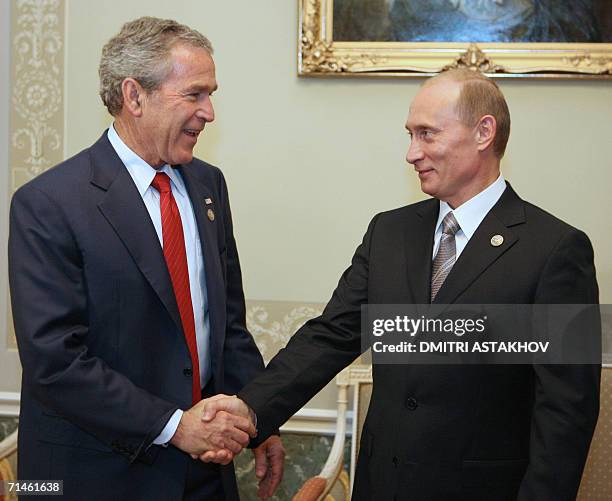 Russian President Vladimir Putin shakes hands with his US counterpart George W. Bush prior to a working session of G8 leaders, invited leaders and...