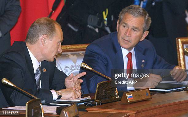 Russian President Vladimir Putin talks next to his US counterpart George W.Bush prior to a working session of G8 leaders, invited leaders and Heads...