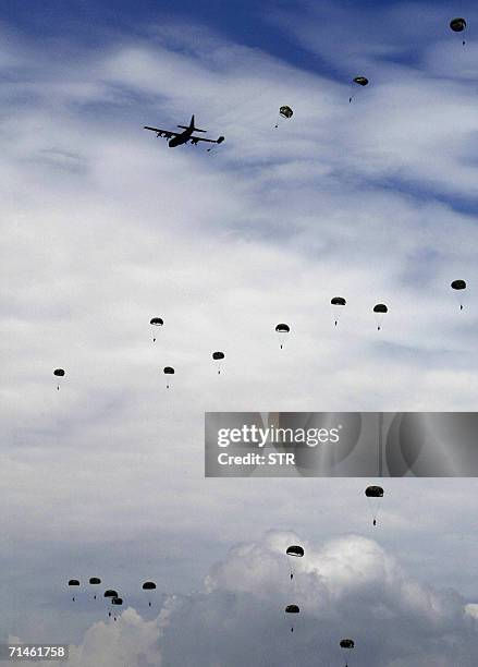 Taiwanese paratroopers parachute from a C-130 transport plane during a rehearsal for the coming military drill at Ilan, northeast of the island, 17...