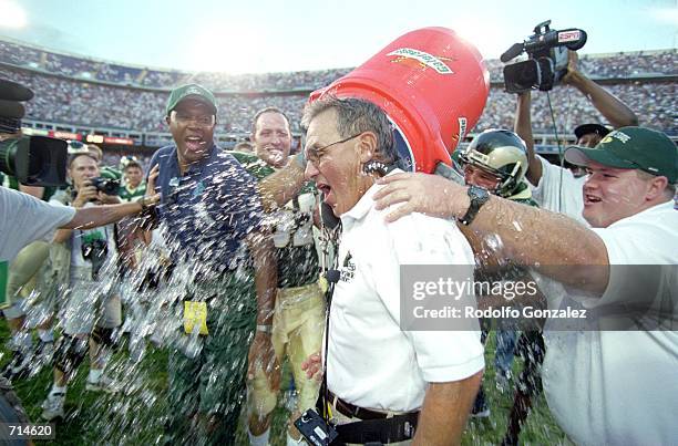 Head Coach Sonny Lubick of the Colorado State Rams gets soaked by his team during the post-game interviews after the game against the Colorado...