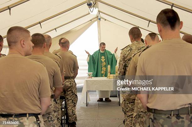 Kinshasa, Democratic Republic of the Congo: Soldiers of the multinational EUFOR troops attend a field mass 16 July 2006 at the N'Dolo camp in...