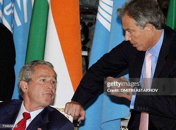 George W.Bush talks to British Prime Minister Tony Blair as Russian President Vladimir Putin walks by during a lunch for G8 Leaders, invited leaders...