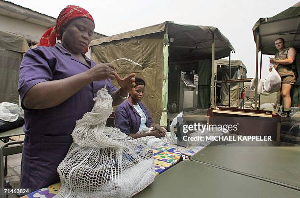 Kinshasa, Democratic Republic of the Congo: Women work at the field laundry of the EUFOR N'Dolo camp in Kinshasa, 14 July 2006. For the first time...