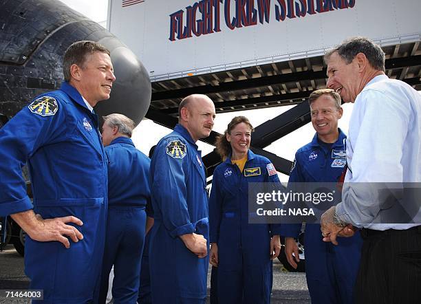 In this handout photo provided by NASA, NASA Administrator, Dr. Michael Griffin talks with STS-121 crew members Mission Specialist, Michael E....