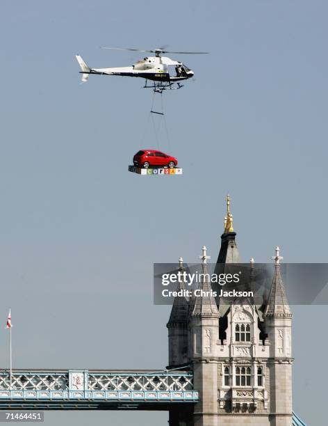 The new Corsa is flown by helicopter over Tower Bridge in a stunt at the Vauxhall Corsa Worldwide Unveiling, at Billingsgate Market on July 17, 2006...