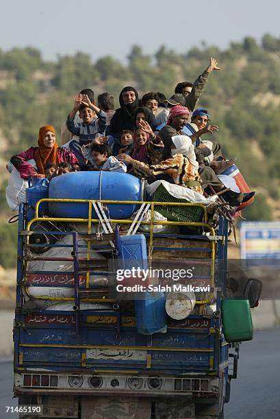 Lebanese citizens arrive on a truck to cross into Syria July 17, 2006 at the checkpoint of al Masnaa, Lebanon. Foreigners and Lebanese residents are...