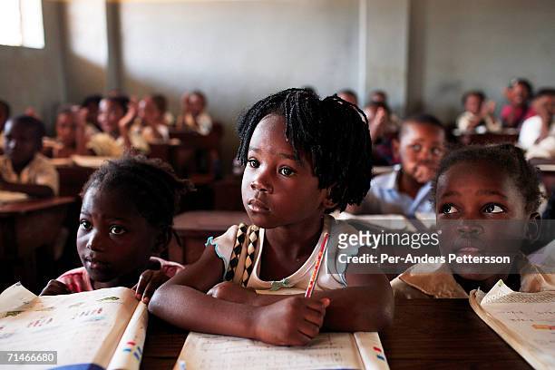 Graca Machel talks to students at 12 Outubro, a primary school in on June 15, 2006 in Maputo, Mozambique. The former first lady is a widow of Samora...