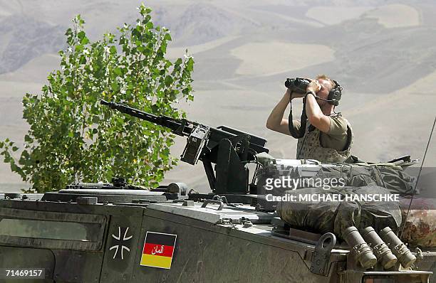 Faizabad, AFGHANISTAN: A soldier of the German armed forces Bundeswehr observes the area at the airport of Faizabad, northern Afghanistan, 18 July...