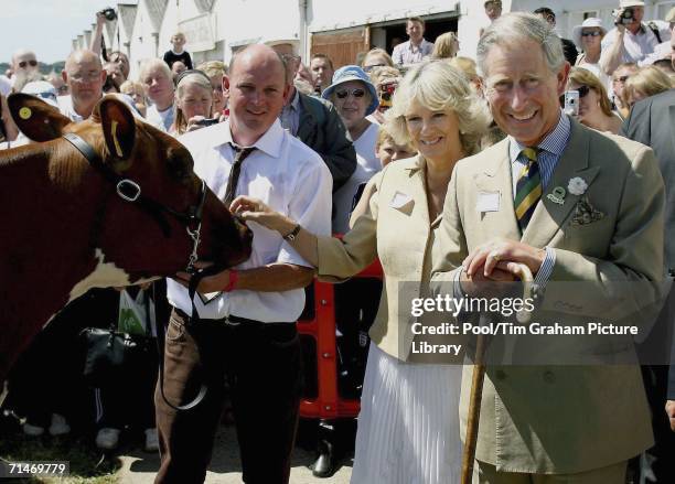 Prince Charles, Prince of Wales and Camilla, Duchess of Cornwall meet a farmer and his Ayrshire cow during their visit to the 148th Great Yorkshire...