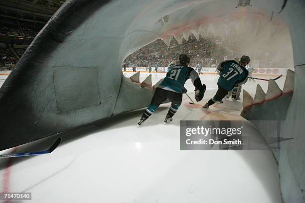 Joe Fahey and Grant Stevenson of the San Jose Sharks skate through the Sharks Head prior to a game against the Washington Capitals on December 16,...