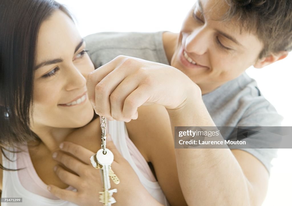 Man handing woman keys