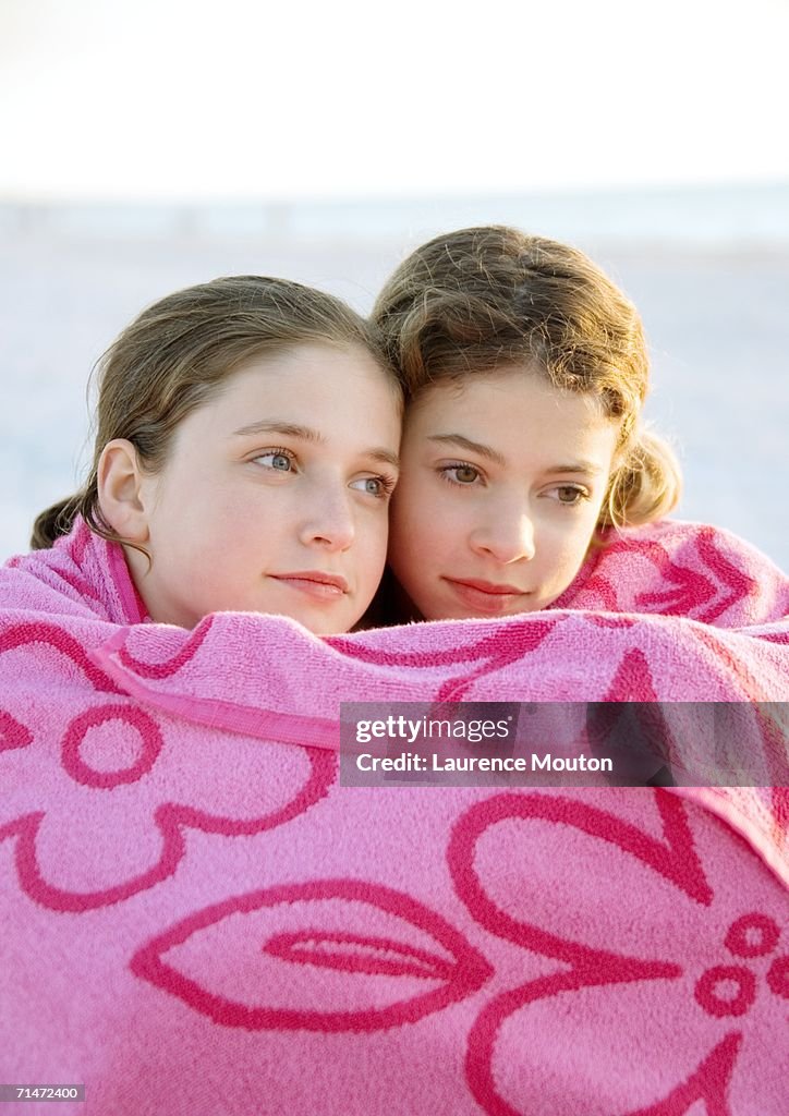 Two girls wrapped in towel together