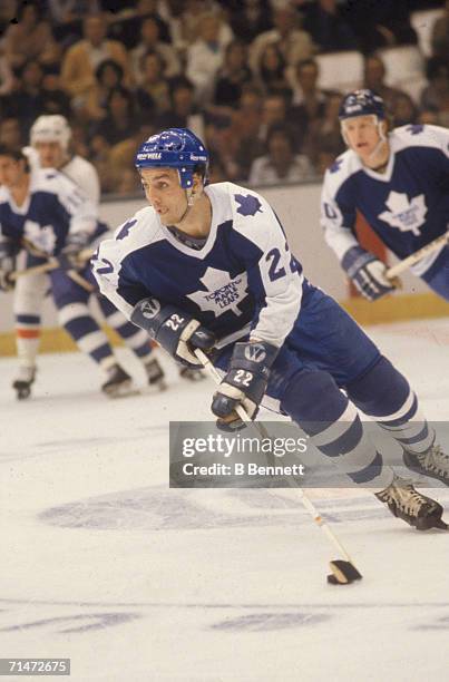 Canadian professional ice hockey player Dave 'Tiger' Williams of the Vancouver Canucks skates skates with the puck on the ice during a game against...