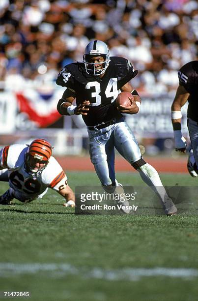 Running back Bo Jackson of the Los Angeles Raiders carries the ball against the Cincinnati Bengals during a game at the Los Angeles Memorial Coliseum...