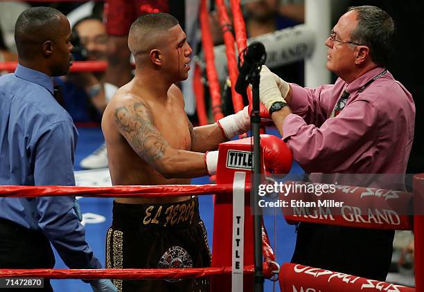 Fernando Vargas walks to his corner as his right eye is bleeding and checked on by a doctor during the 5th round of the junior middleweight rematch...