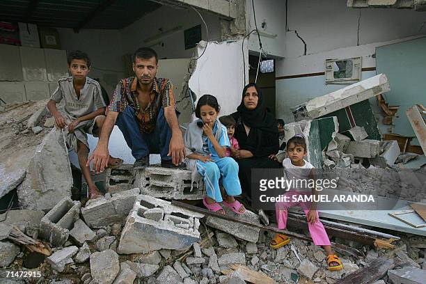 Palestinian Khalid Ahmed Nasir , 34-years-old, is seen with all his family sitting in front of the remains of his home destroyed by the Israeli army...
