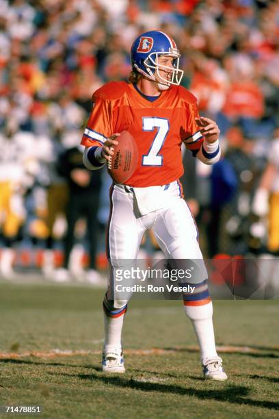 Quarterback John Elway of the Denver Broncos drops back to pass during the 1989 AFC Divisional Playoff Game against the Pittsburgh Steelers at Mile...