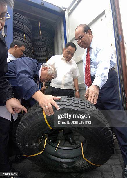 Bureau of Customs commissioner Napoleon Morales with deputy commisioner Celso Templo and security director Nestorio Gualberto inspects a shipment of...