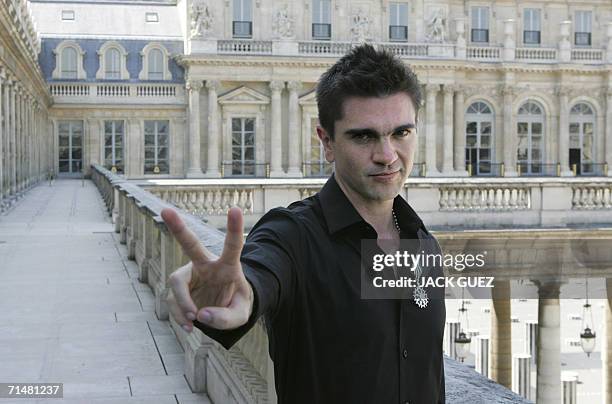 Colombian singer Juanes poses after receiving the insigna of knight of Arts and Letters from French Minister for Culture and Communications Renaud...