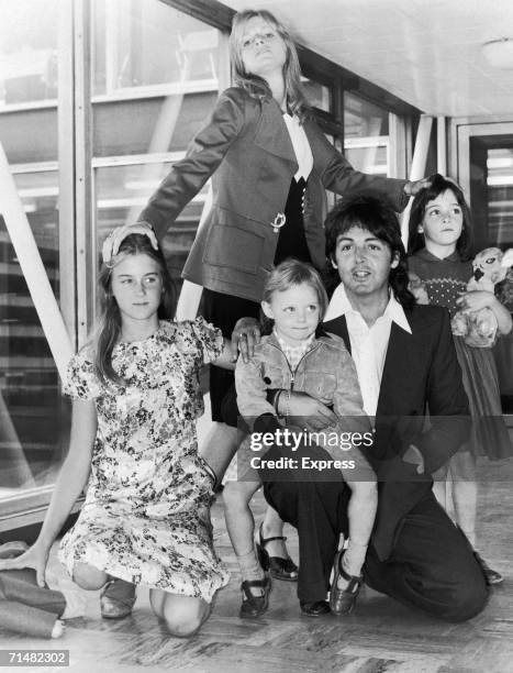 British singer and songwriter Paul McCartney poses with his wife Linda , and their daughters, left to right, Heather, Stella and Mary at an airport,...