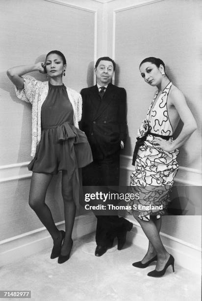American fashion designer James Galanos leans in a corner at a Saks Fifth Avenue department store, his hands in the pockets of his double-breasted...
