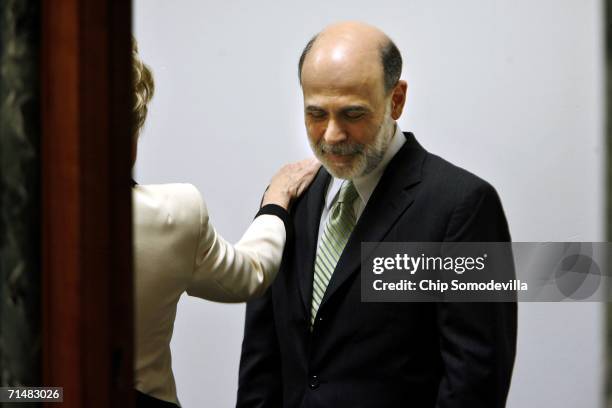 Senator Elizabeth Dole pats Federal Reserve Chairman Ben Bernanke on the shoulder before he testifies in front of the U.S. Senate Banking, Housing...