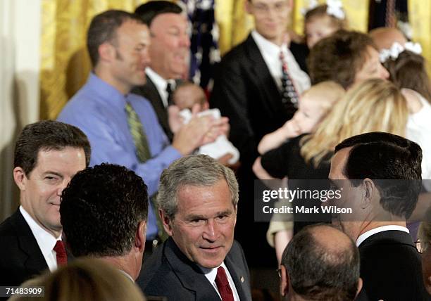 President George W. Bush flanked by Sen. Rick Santorum and Sen. Sam Brownback greets members of the audiance after speaking about rejecting a Senate...