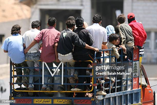 Syrian workers head to cross the Lebanese-Syrian border on July 19, 2006 at Masnaa, Lebanon. Two Israeli soldiers and one Hezbollah militant were...