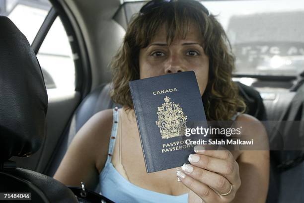 Canadian citizen shows her passport as arrives at the Lebanese-Syrian border on July 19, 2006 at Masnaa, Lebanon. Two Israeli soldiers and one...