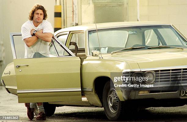 Marc Ellis of the New Zealand All Blacks poses with his Chevy Impala June 26, 1996 in New Zealand. Ellis is a former New Zealand rugby league and...